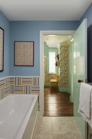 Blue bathroom with patterned wallpaper