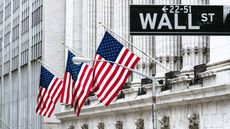 Wall Street sign with American flags