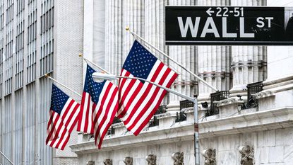 Wall Street sign with American flags