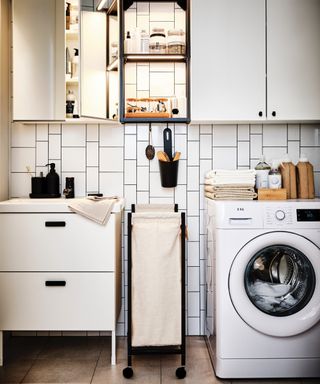 Small bathroom with washing machine one side, small vanity on the other, hanging wall units, storage solutions