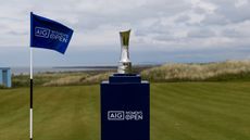 A general view of the AIG Women's Open trophy on a stand at Royal Porthcawl with a flag to the left