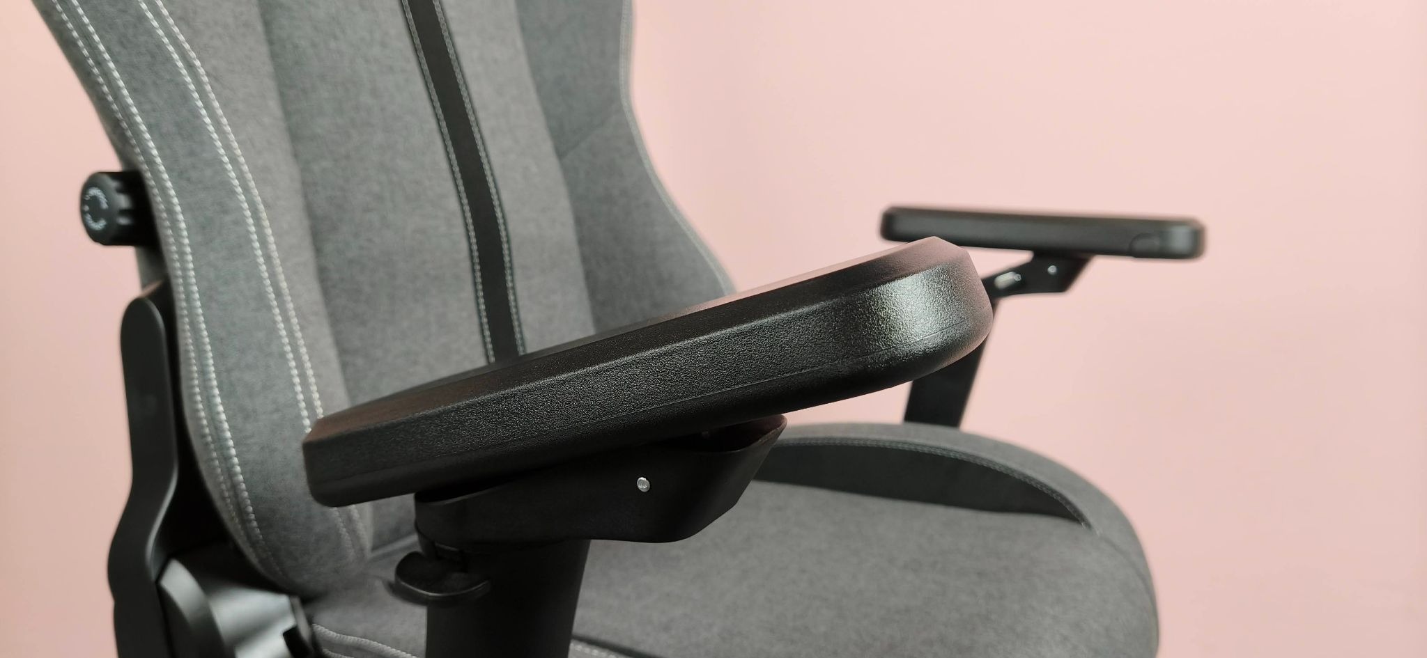 Close-up of armrests on Boulies Master Rex (2026), against a pink background