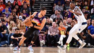 Devin Booker #1 of the Phoenix Suns handles the ball against the Dallas Mavericks