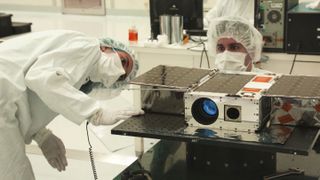 Engineers work on the ASTERIA cubesat in April 2017, before its launch.