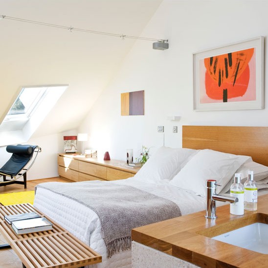 bedroom with white wall bed linen and wall art