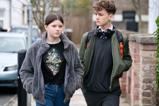 Lily Slater and Ricky Mitchell walk side by side in EastEnders 