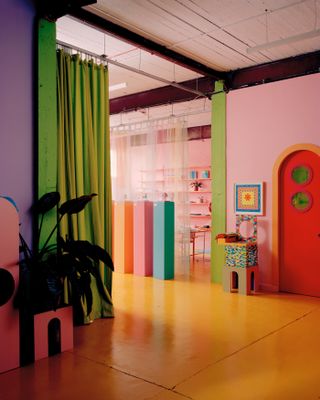 Green curtain divides space at colourful Yinka Ilori London office