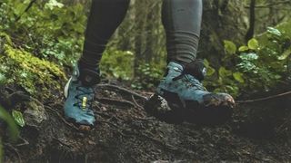 Woman's feet wearing Salomon Cross Hike Mid GTX hiking boots