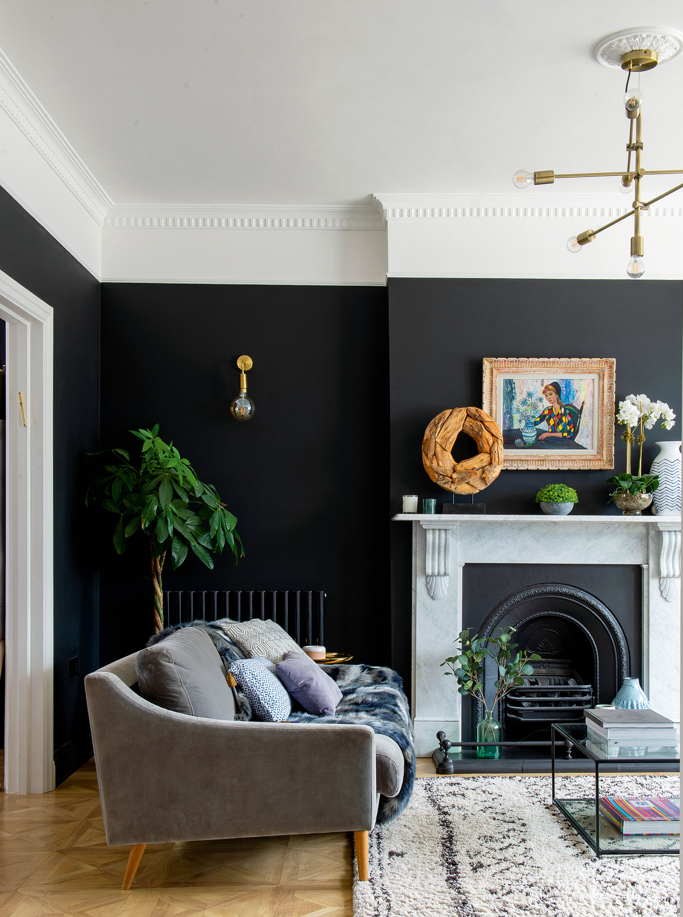 Living room idea with black wall and wooden floor