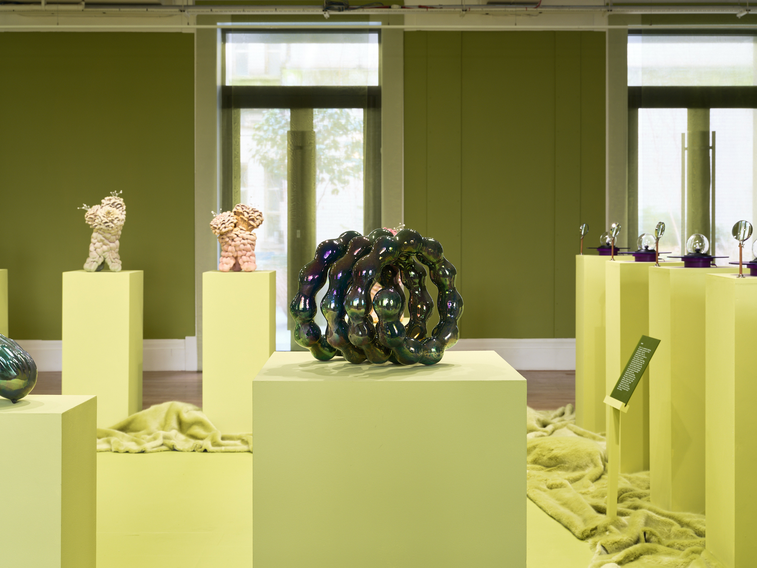 Futuristic ceramics in green gallery space