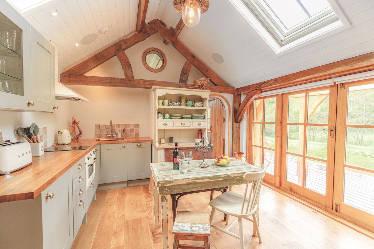 small green kitchen diner with vaulted ceiling