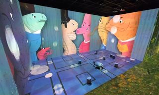 Christie laser projectors fill walls with colorful cartoon characters.