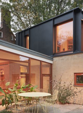 exterior at dusk and lit from inside, of the Hampstead House by Coppin Dockray