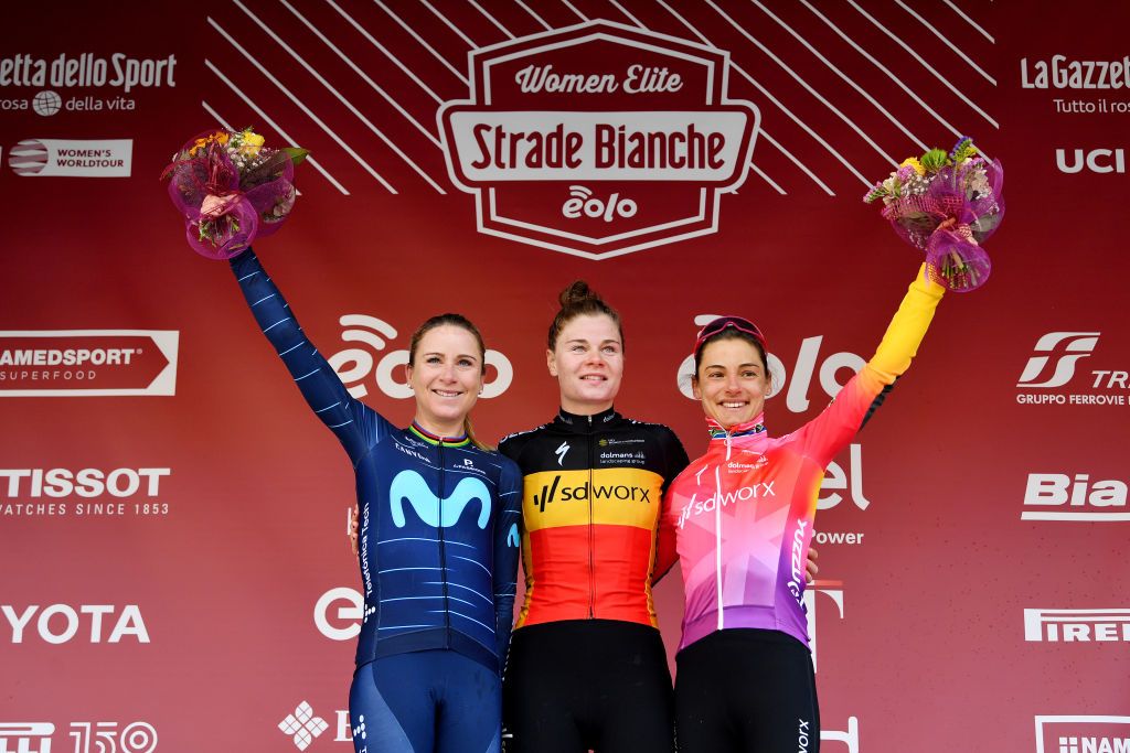 SIENA ITALY MARCH 05 LR Annemiek Van Vleuten of Netherlands and Movistar Team on second place race winner Lotte Kopecky of Belgium and Team SD Worx and Ashleigh Moolman Pasio of South Africa and Team SD Worx on third place pose on the podium during the podium ceremony after the Eroica 8th Strade Bianche 2022 Womens Elite a 136km one day race from Siena to Siena Piazza del Campo 321m StradeBianche on March 05 2022 in Siena Italy Photo by Luc ClaessenGetty Images