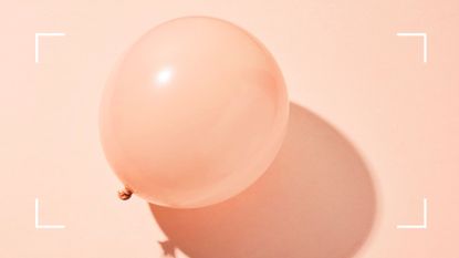 Studio photo of a light pink balloon ready to burst on pink background, representing the link between gut health and anxiety