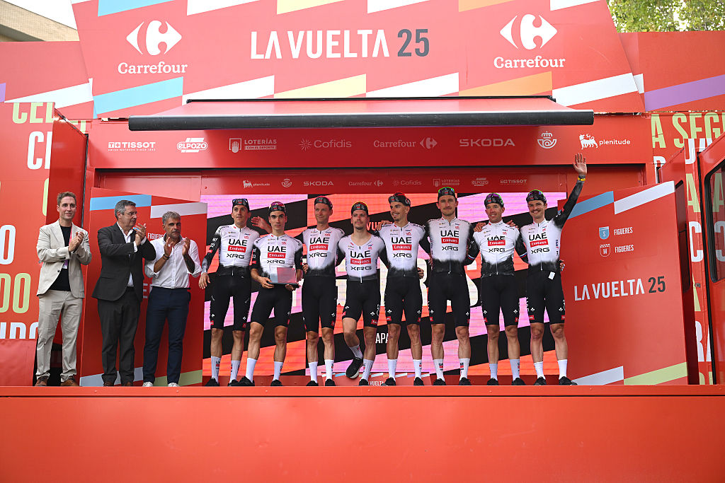 FIGUERES, SPAIN - AUGUST 27: Joao Almeida of Portugal, Juan Ayuso of Spain - White Best Young Rider Jersey, Mikkel Bjerg of Denmark, Felix Grossschartner of Austria, Domen Novak of Slovenia, Ivo Oliveira of Portugal, Marc Soler of Spain, Jay Vine of Australia and UAE Team Emirates - XRG celebrate at podium as stage winners during the La Vuelta - 80th Tour of Spain 2025, Stage 5 a 24.1km team time trial stage from Figueres to Figueres / TTT / #UCIWT / on August 27, 2025 in Figueres, Spain. (Photo by Dario Belingheri/Getty Images)