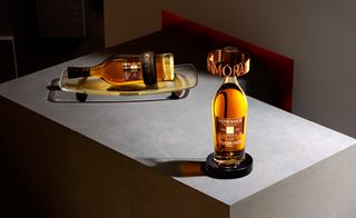 Two bottles of whisky on small display stands, grey stone display block stand