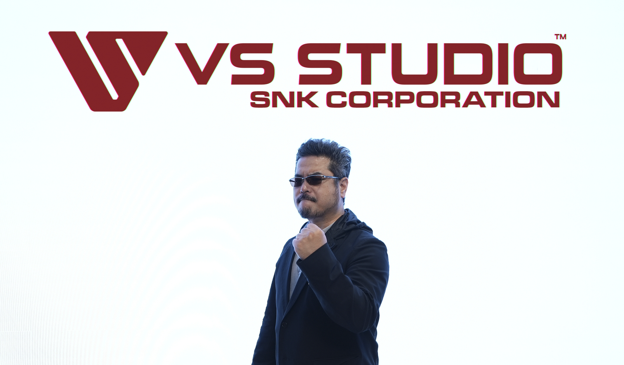 VK Studio CEO Katsuhiro Harada stands in front of the studio logo.
