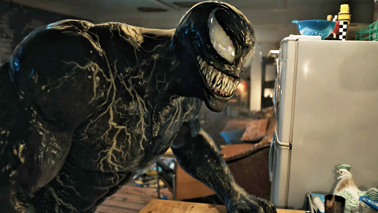 Venom, standing in Eddie's apartment, as he appeared in Venom: Let There Be Carnage (2021).