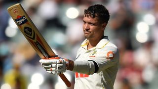 Australia's Alex Carey holds his bat to the crowd after reaching a century during the Ashes 3rd Test