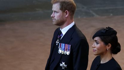 Prince Harry and Meghan, Duchess of Sussex walk as procession with the coffin of Britain's Queen Elizabeth arrives at Westminster Hall from Buckingham Palace for her lying in state on September 14, 2022 in London, United Kingdom. Queen Elizabeth II's coffin is taken in procession on a Gun Carriage of The King's Troop Royal Horse Artillery from Buckingham Palace to Westminster Hall where she will lay in state until the early morning of her funeral. Queen Elizabeth II died at Balmoral Castle in Scotland on September 8, 2022, and is succeeded by her eldest son, King Charles III.