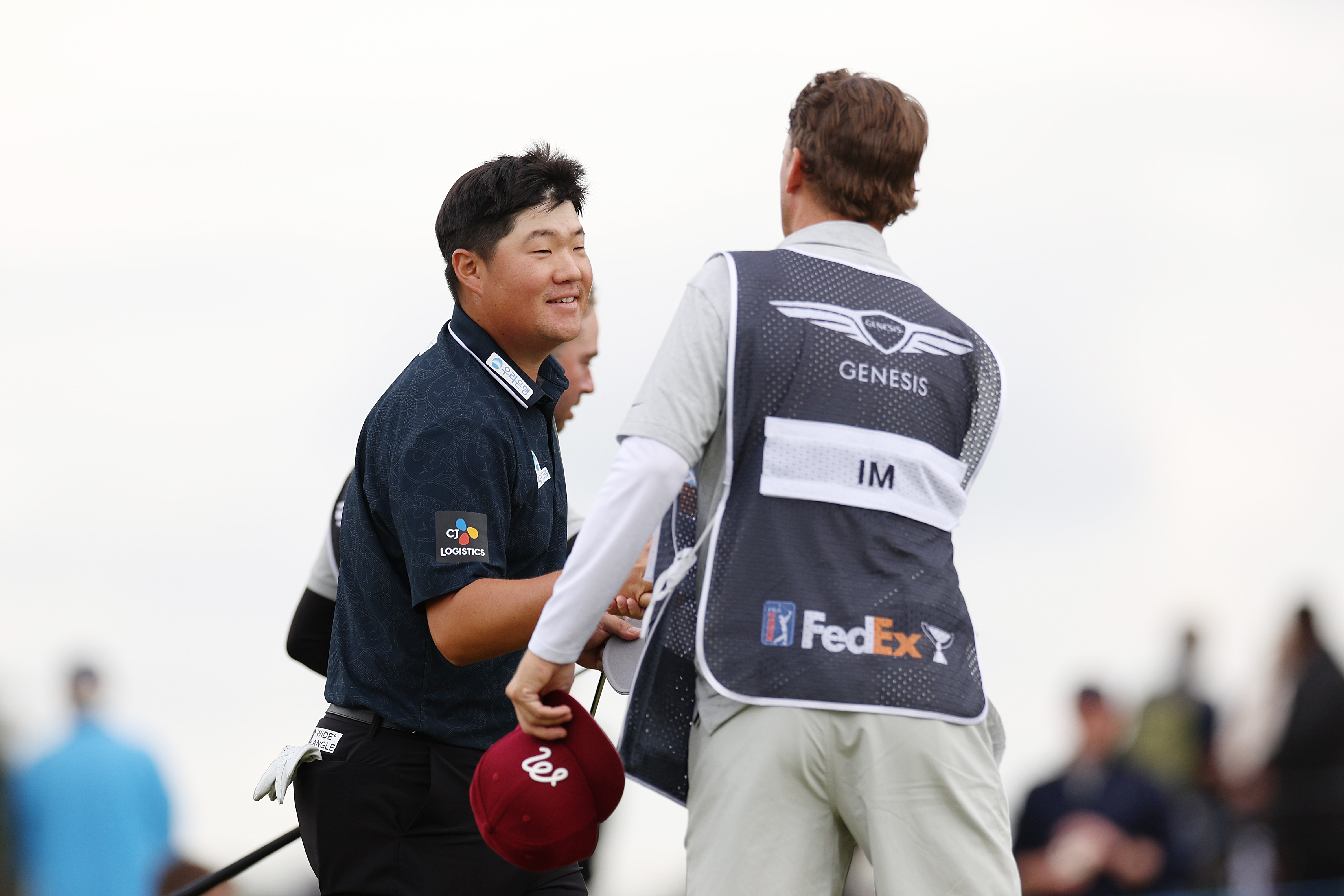 Sungjae Im shakes hands with his caddie at the Genesis Scottish Open