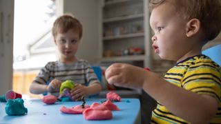 Sensory play illustrated by kids playing play dough