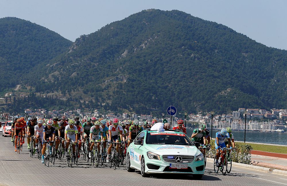 Riders wait behind the official vehicle for the neutral start.