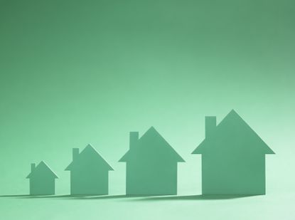 Silhouettes of 4 houses on a green background