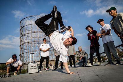Jong Ho "Leon" Kim of Korea performs as the other B-Boys watch on during a video production prior to this weekend's Red Bull BC One breakdancing world final, on November 11, 2015 in Rome, Ita