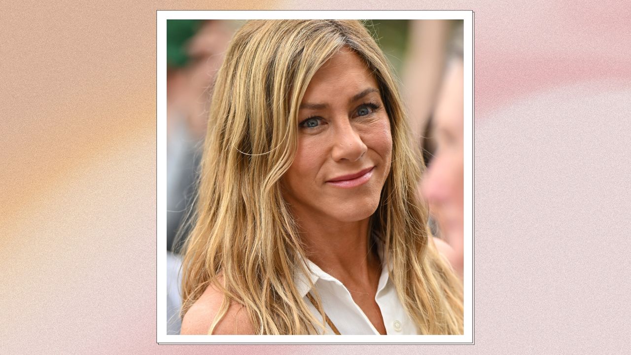 Image of Jennifer Aniston smiling with side part blonde hair and wearing a sleeveless white shirt, on a pink watercolour background