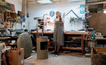 Woman stood in front of workbench 