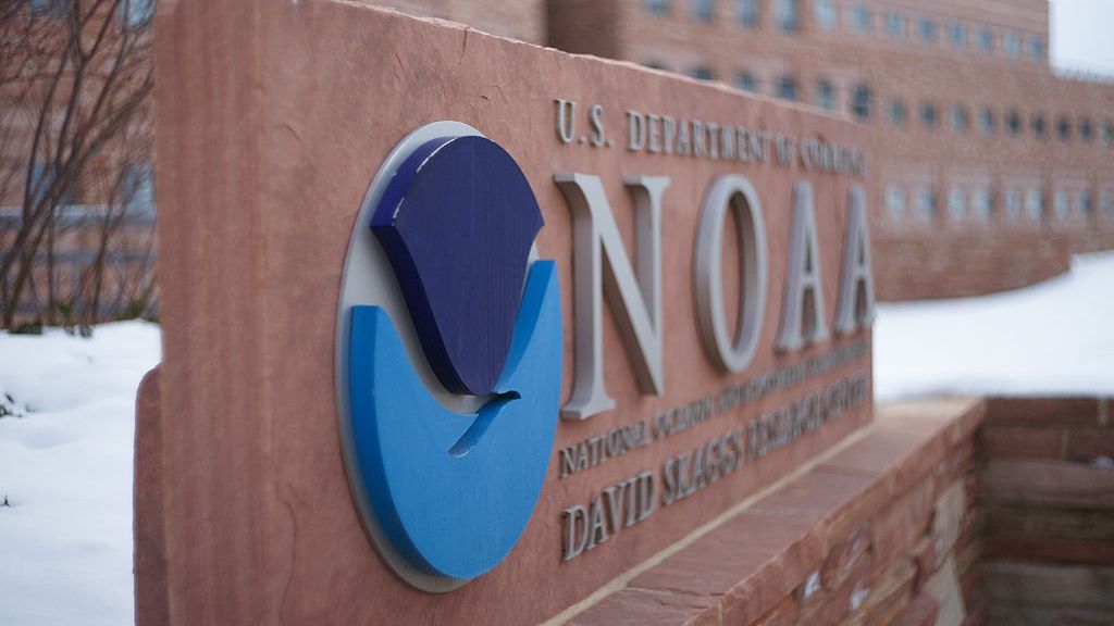 The sign outside an NOAA building. There is the NOAA logo on it.