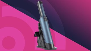 Shark WandVac car vacuum on a pink background