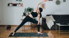 Woman practising yoga at home