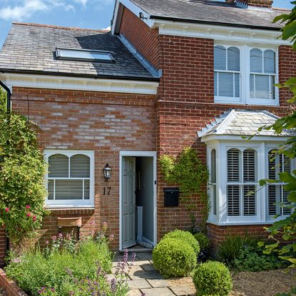 brick house exterior with porch and front door