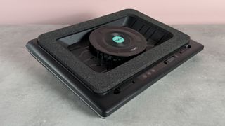 The Llano RGB Laptop Cooling Pad at a 3/4s angle in front of a pink background.