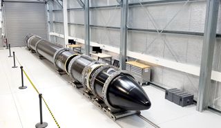 An Electron rocket (named "It's a Test") arrives at Rocket Lab's launch complex ahead of the company's first test flight
