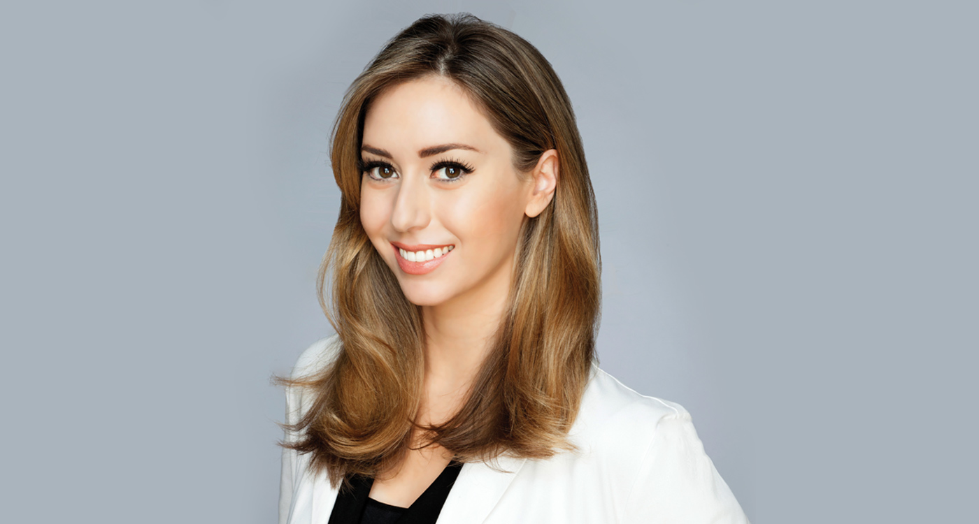 Shereene Idriss in a white lab coat