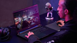 Gamer using the Gigabyte AORUS 15 gaming laptop to play a racing game