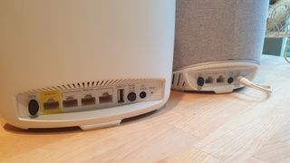 The rears of the Orbi Voice and the Orbi router