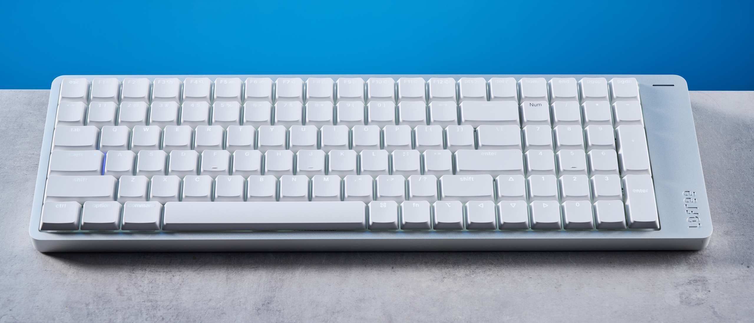 The Lofree Flow 2 on a stone surface with a blue background