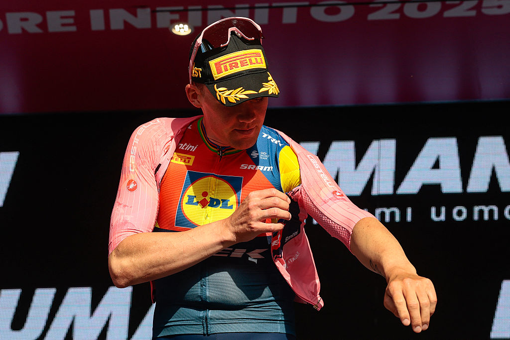 Lidl-Trek's Danish rider Mads Pedersen puts on the overall leader's pink jersey (Maglia Rosa) on the podium after the 4th stage of the 108th Giro d'Italia cycling race 189kms from Alberobello to Lecce on May 13, 2025. (Photo by Luca Bettini / AFP)