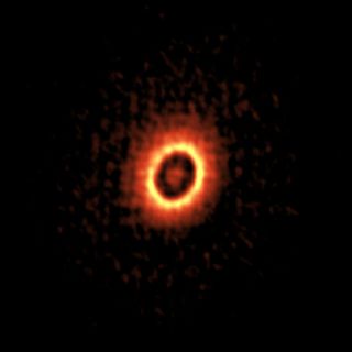ALMA image of the dusty disk around the young star DM Tau. Two concentric rings, where planets may be forming, are visible.
