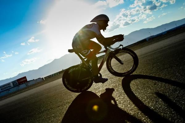 A rider passes by as the sun gets lower in the sky.
