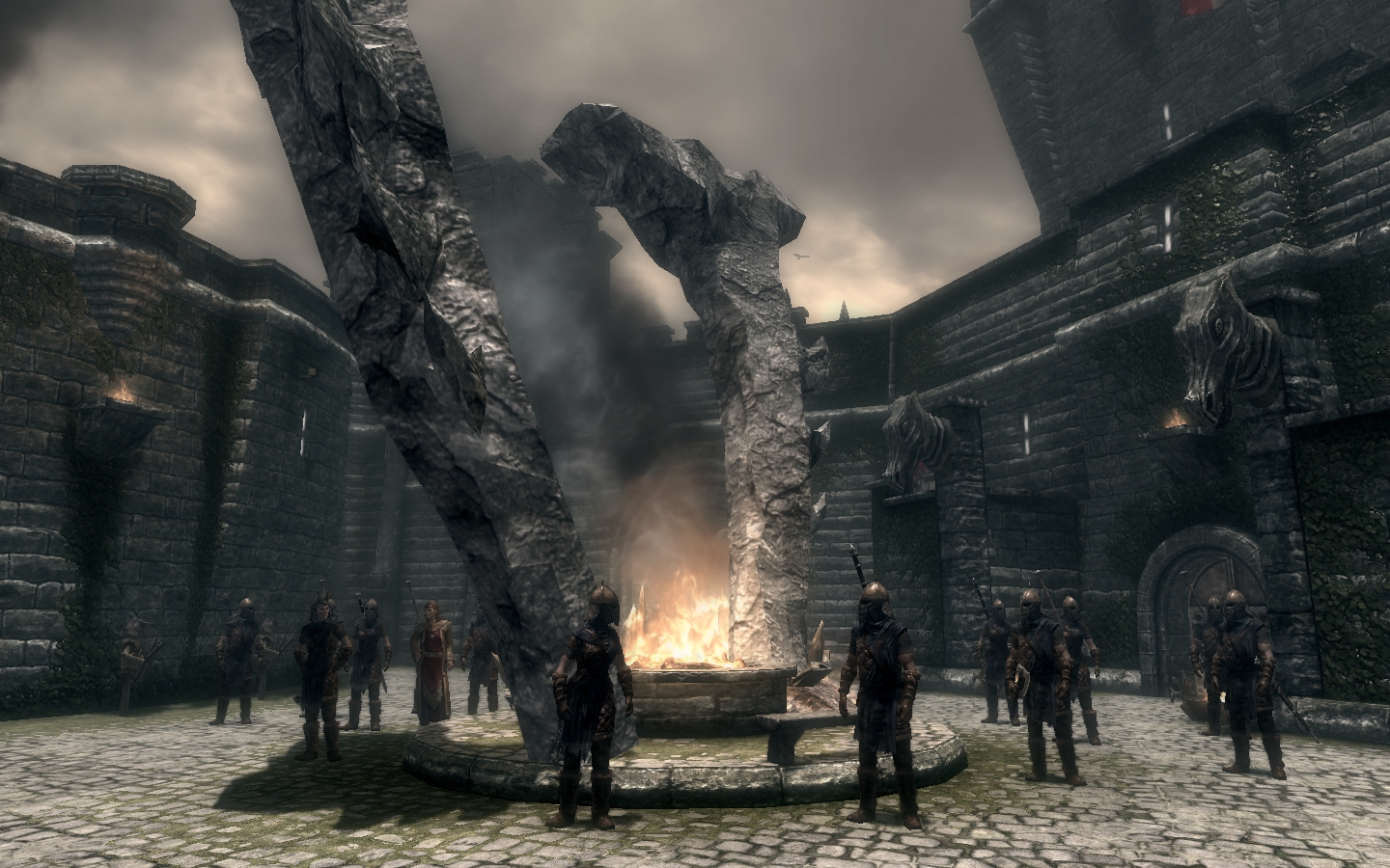 A broken Oblivion gate standing over a fire.