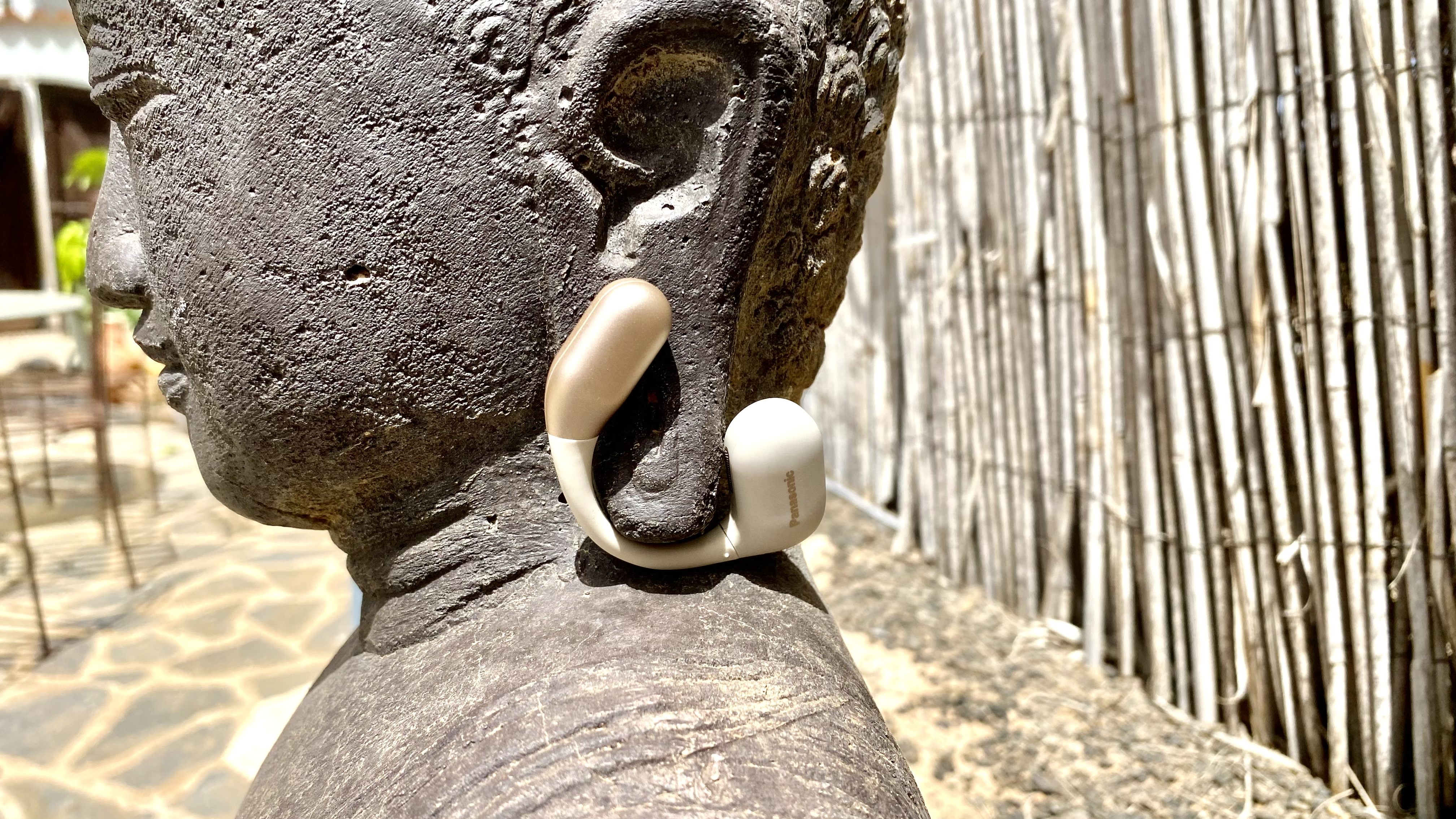 Panasonic RB-F10 open earbuds sat on a stone head