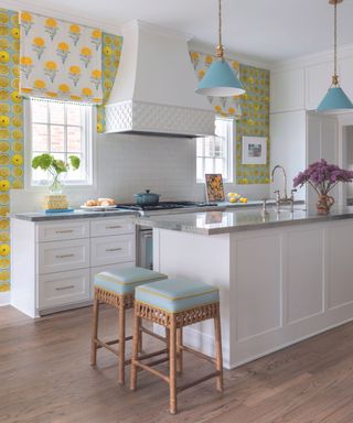 Kitchen wall mural in yellow and green with white kitchen in front