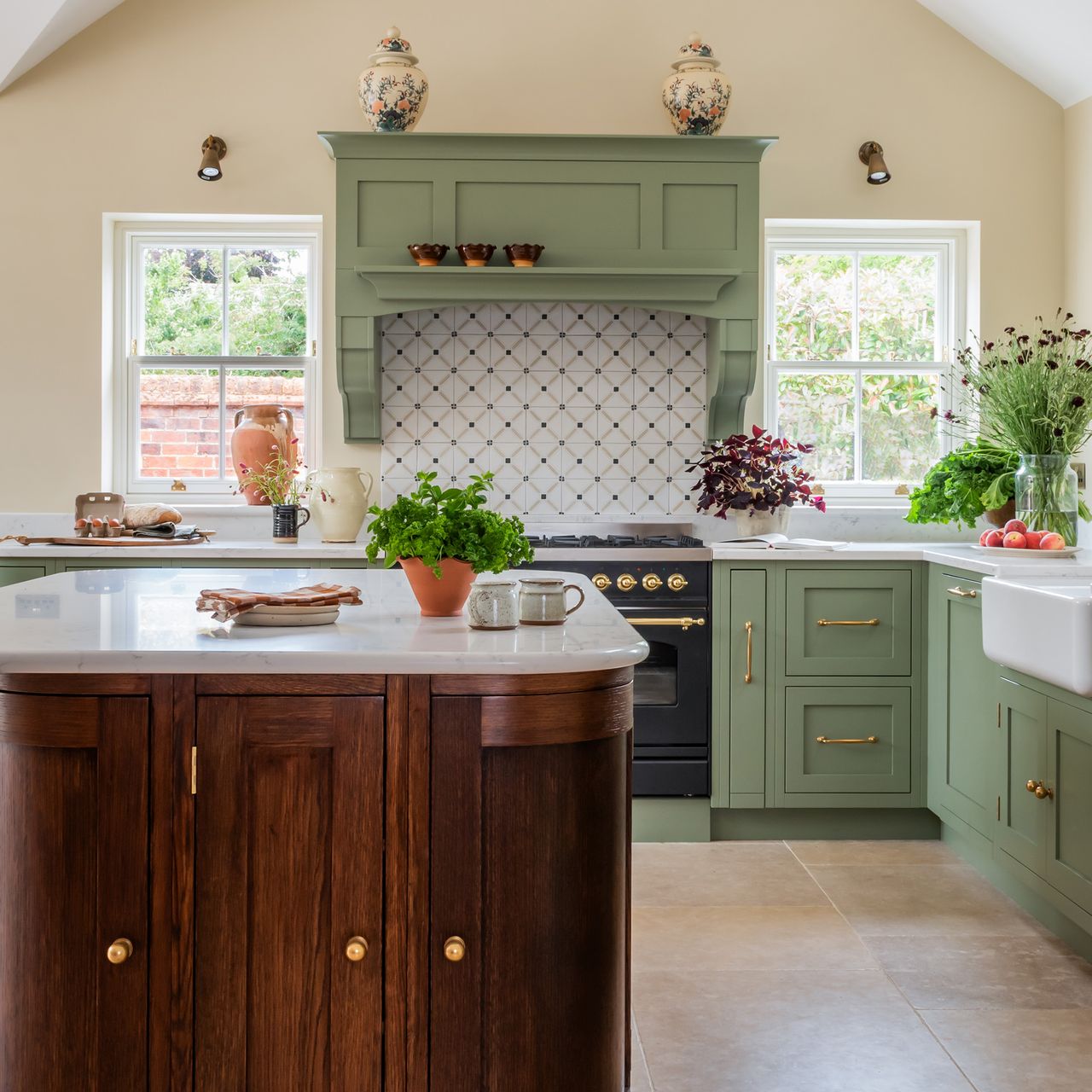 kitchen with cream wall green cabinetry and wooden curved kitchen island 