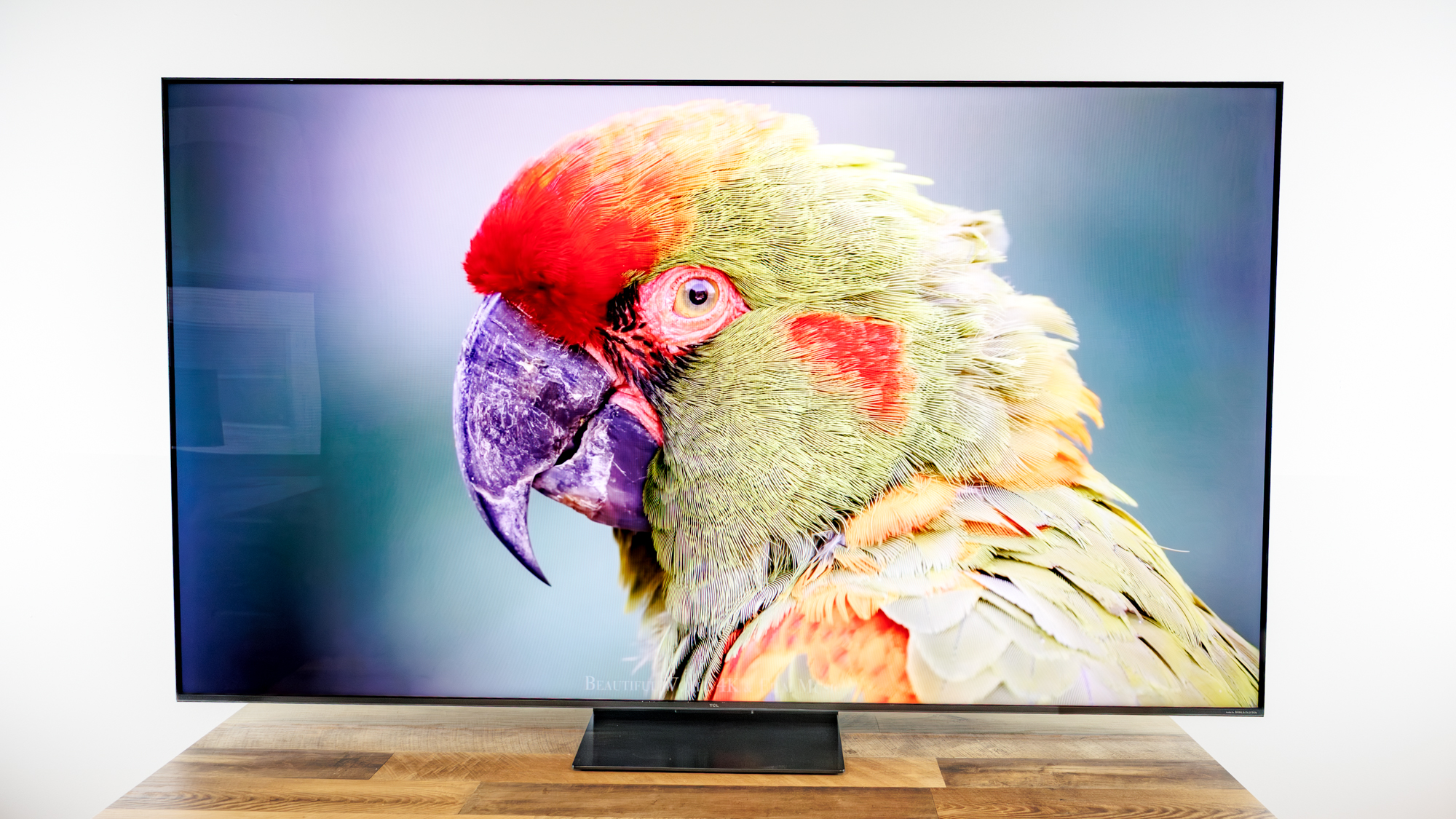 TCL QM7L 75-inch TV on a desk